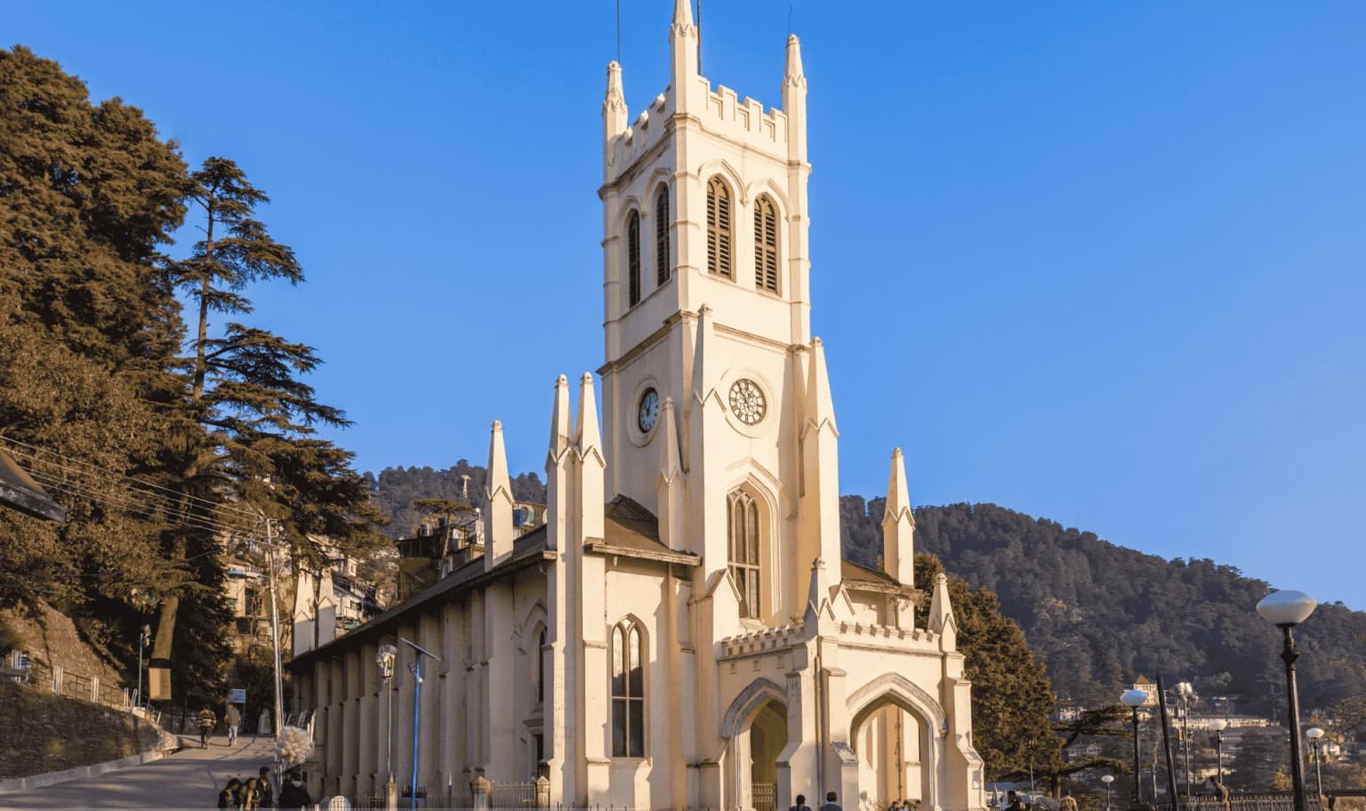 Christ Church on the Ridge in Shimla, lit by evening sun under a clear blue sky